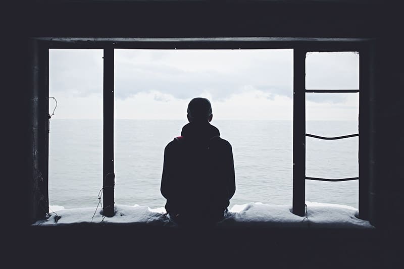 A guy alone, looking at the sea