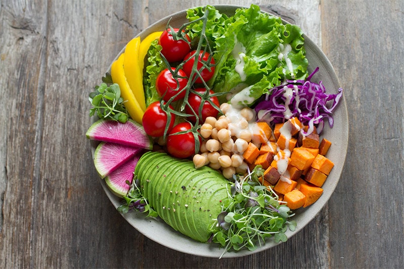 Vegan salad with lettuce, cherry tomatoes, cabbage, pumpkin, chickpeas and avocado